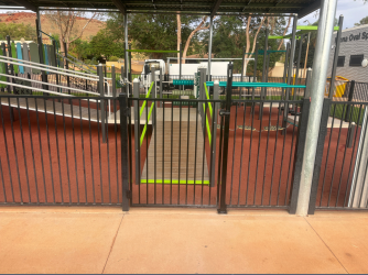 Metal fence and gate at a Tom Price playground