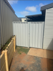 White metal gate at Onslow staff housing